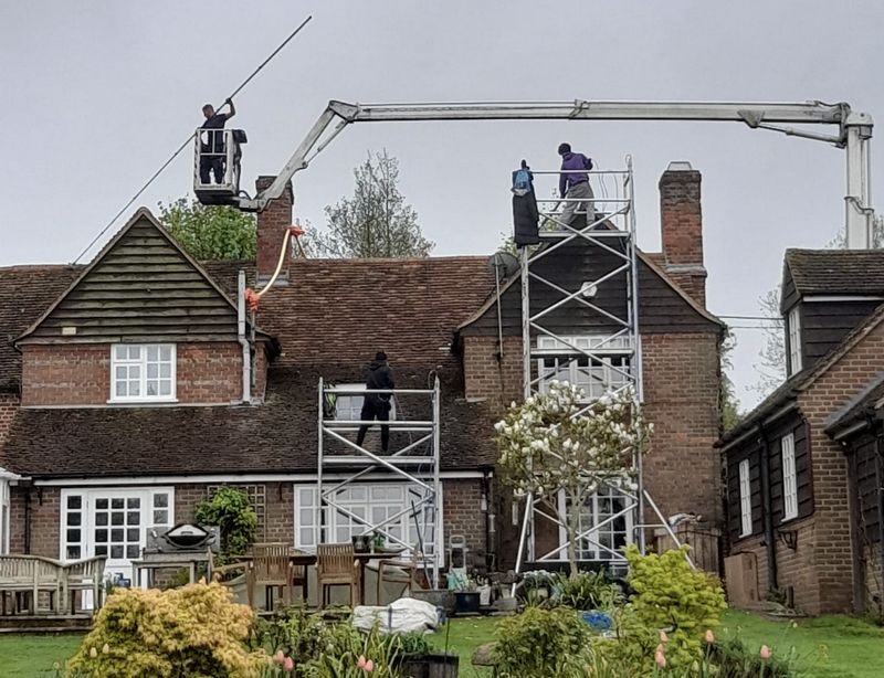 The Roof Moss Cleaners using cherry picker and scaffolding to clean roof safely and professionally in Chalfont St Giles, Buckinghamshire